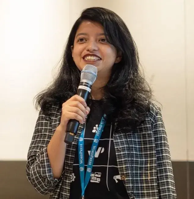 Smiling while speaking into a microphone