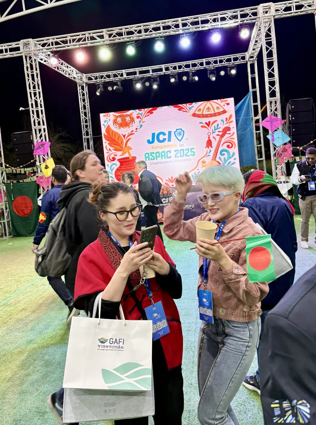Mongolian delegates waving a Bangladesh flag at Bangladesh Night