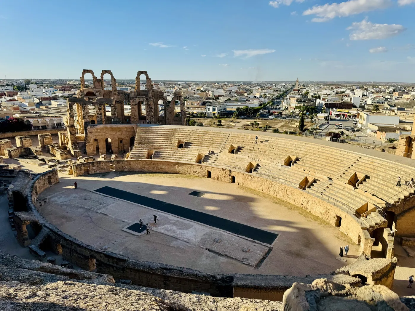 Looking down into the arena of El Jem with the town behind it