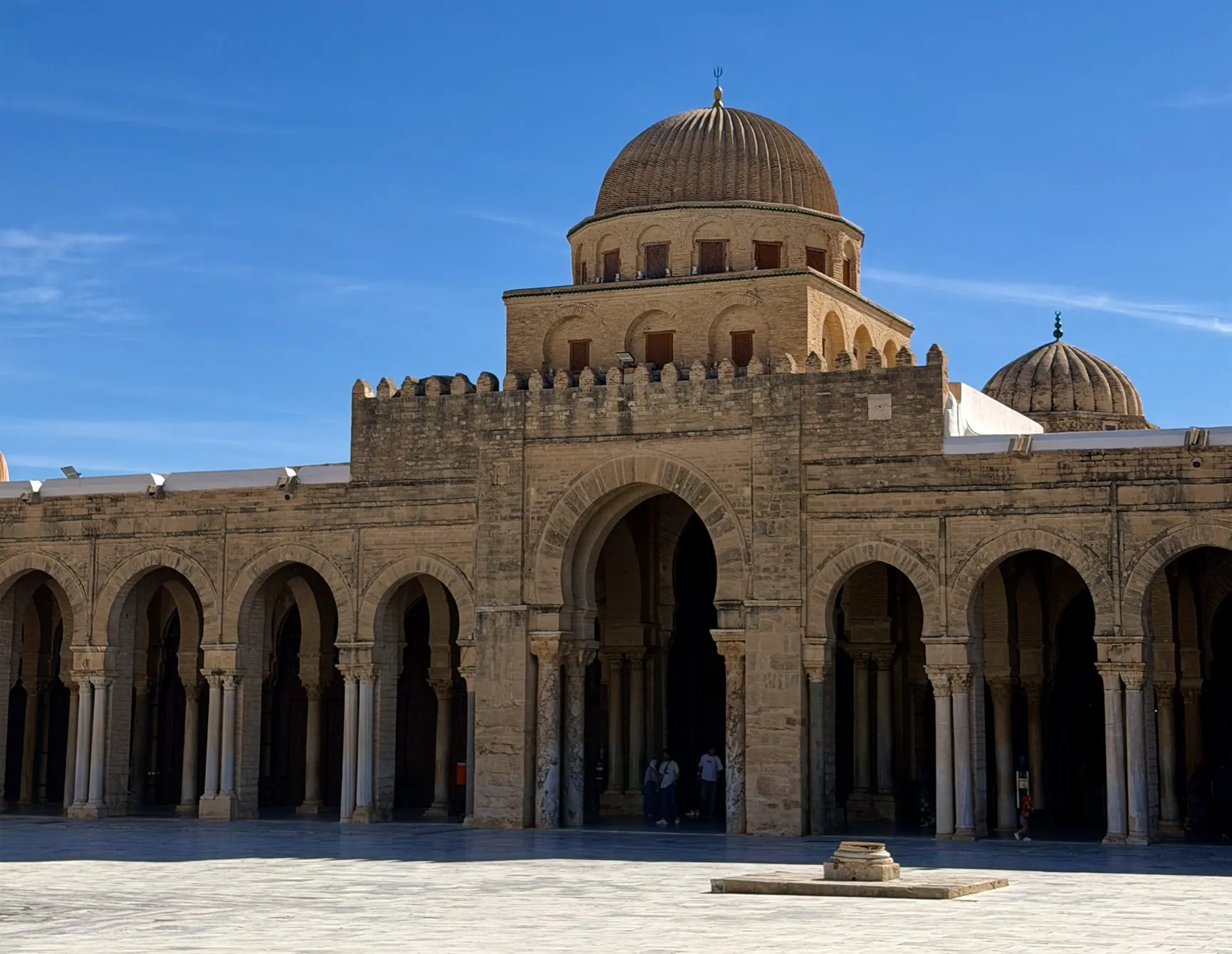 The Great Mosque of Kairouan under a clear blue sky