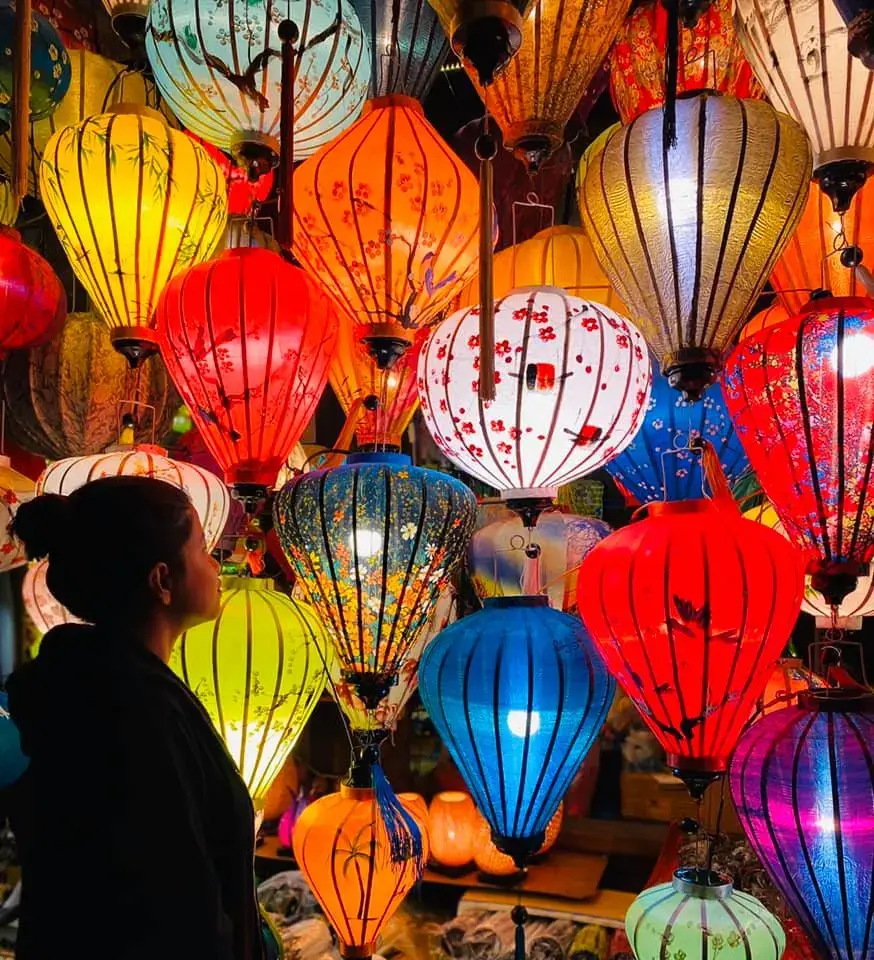 Afshana among hundreds of colorful silk lanterns in Hoi An