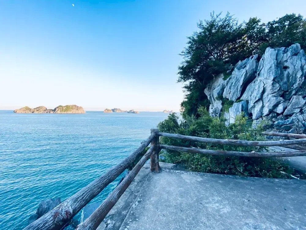 A cliffside walkway looking out over the sea and distant islands