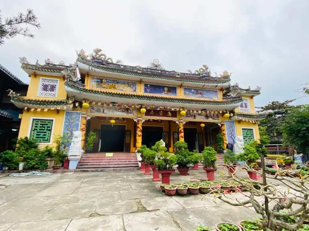 A yellow temple with curved roofs in the old town of Hoi An