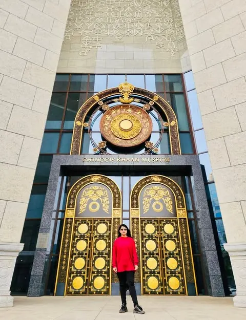Afshana Diya in front of the golden doors of the Genghis Khan Museum in Ulaanbaatar