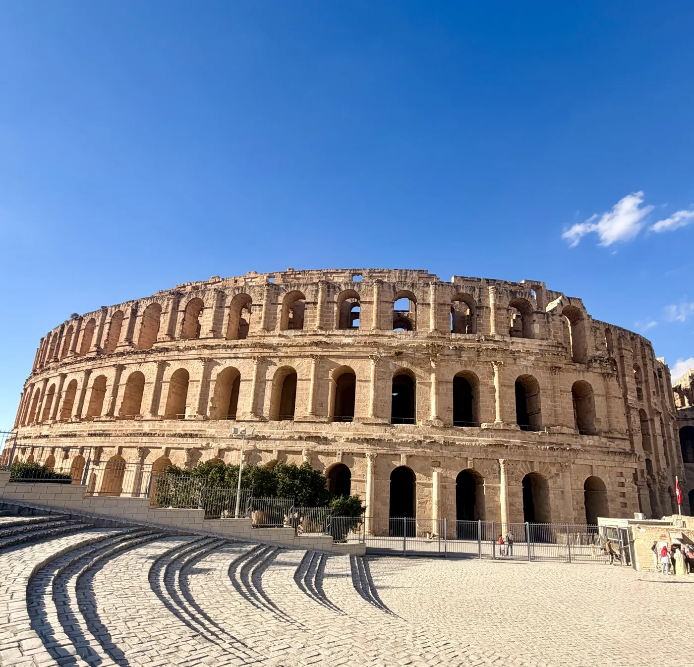 The Roman amphitheatre of El Jem under a blue sky